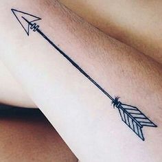 an arrow tattoo on the arm