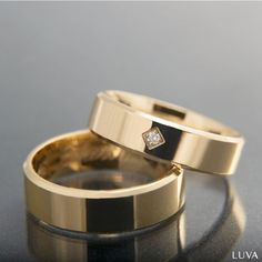 two gold wedding rings with diamonds on them