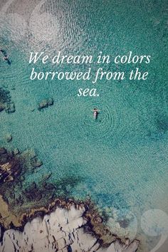 an aerial view of a body of water with the words, we dream in colors borrowed from the sea