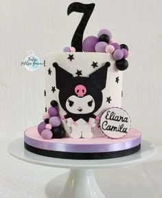 a birthday cake decorated with balloons and a cat on it's top is the number one