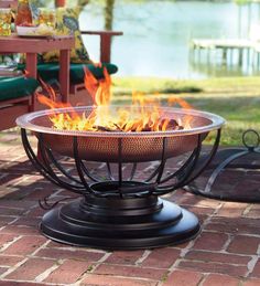 a fire pit sitting on top of a brick patio