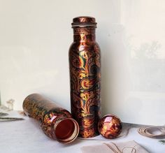 a bottle and some other items sitting on a white table cloth next to each other