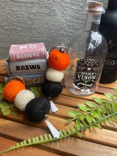 an assortment of items sitting on top of a wooden table next to a bottle of booze