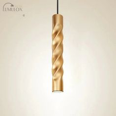 a gold colored pendant light hanging from a black cord on a white background with the words unplox written below it