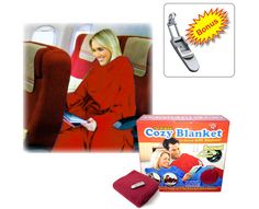 a woman in red is sitting on an airplane with a blanket and toothbrush next to it