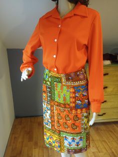 This is a cute retro 1960s or 1980s a line midi skirt. The patchwork paisley and floral pattern is really cute. The orange, green and blue colors are vibrant. There are no holes or fading!  The skirt zips up the back and is ready to wear! This would be fun for fall! Wear it out and about, to work or the farmer's market. Very nice with some boots or sandals. It would look great with an orange or green blouse or even a bright sweater.  The size is a small to medium. Measurements are across the front of the skirt.  Waist 14" Hips 18" Length 23" Free shipping in the USA. No returns. Message me with any questions. Bright Sweater, Solid Color Outfits, Fall Wear, Farmer's Market, Green Blouse, Brown Floral, Paisley Pattern, Orange Yellow, Fall Colors