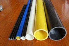 several different types of plastic pipes on a wooden floor