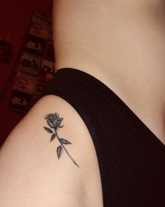 a woman's arm with a rose tattoo on the left side of her body