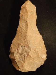 a large rock sitting on top of a black surface