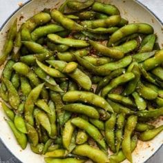 green beans are being cooked in a skillet