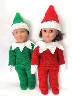 two crocheted dolls wearing christmas outfits, one is green and the other is red