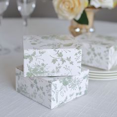 two white boxes sitting on top of a table