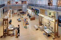 an overhead view of the inside of a building with people looking at items on tables