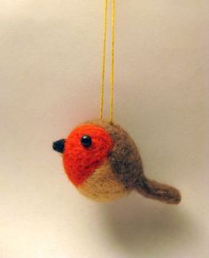 a small bird ornament hanging from a string