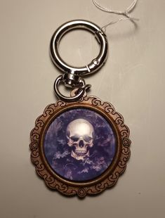 a keychain with a skull on it and a chain hanging from the front