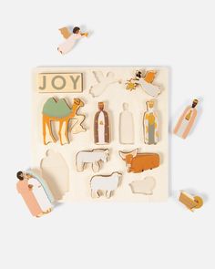 an assortment of wooden toy animals on a white background with the word joy written in large letters