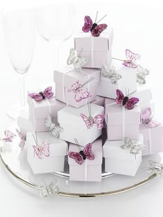 there is a cake that has many small boxes on it and butterflies on the top