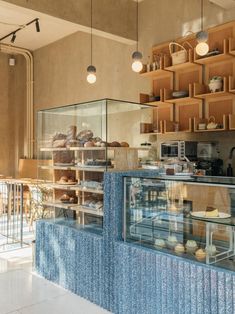 a bakery with lots of baked goods behind the counter