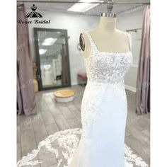 a white wedding dress on display in a store