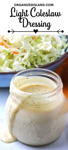 a jar filled with dressing next to a bowl of coleslaw