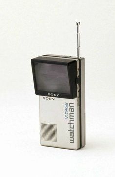 an old portable television sitting on top of a white table