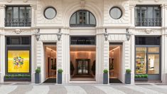 the entrance to a luxury store in an old european building with arched windows and balconies