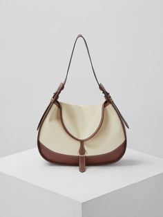 Editor's NoteArchivepke's bags are designed in classic and minimal design. - Hobo bag style- Canvas and leather combination- Wide and stable top handle- Round flap with a strap buckle- Classic and feminine mood Measurements (in.)- Size: 11.42 in. (W) * 8.46 in. (H) * 2.76 in. (D)- Strap: 9.06 in. (H) * 22.05 in. (L) - Total Width: 9.45 in. (Top) / 11.42 in. (Bottom) Composition & Care- Material: Canvas + Synthetic Leather- Natural leather may have fine scratches and wrink Shoulder Bag With Handle Drop For Errands, Daily Use Coated Canvas Bucket Bag With Detachable Strap, Bucket Bag With Detachable Strap And Double Handle, Double Handle Bucket Bag With Detachable Strap, Classic Hobo Bag With Top Handle, Leather Baguette Bag In Beige For Errands, Leather Shoulder Baguette Bag With Handles, Leather Baguette Shoulder Bag With Handles, Beige Leather Baguette Bag For Errands