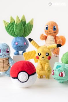 crocheted pokemon amigurt toys are lined up on a white table top