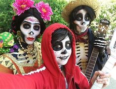 three people in skeleton makeup are posing for the camera with their guitars and hats on