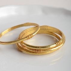 Need a wardrobe refresh? Add some flash and flair to your everyday look with our stunning new bangles by Julie Vos. Each piece is handcrafted, set in 24k gold plate, and sealed to prevent tarnish, making it the perfect touch of intrigue and glamour to your daily life. voss, julia, jewelry, bracelet 22k Gold Jewelry Bangles, Cheap Classic Gold Bangle, Affordable Classic Gold Bangle, Cheap Everyday Bangle Jewelry, Cheap Classic Round Bangle, Cheap Elegant Gold Bangle, Traditional Luxury Gold Bangle, Luxury Traditional Yellow Gold Bangle, Cheap Traditional Style Bangle Jewelry