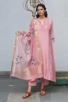 Prism pink kurta with embroidered v-neckline. Paired with inner slip, pants and dupatta. 
Component: 4
Embroidered
Neckline: V-Neck
Sleeve Length: Three Quarter
Fabric: Kurta and Dupatta: Chanderi; Pants: Cotton
Color: Pink
Asymmetric hem
Scallop hem sleeves
Embroidered dupatta with tassels - Aza Fashions Kurta And Dupatta, Pink Kurta, Women Kurta, Cotton Slip, Straight Kurta, Work Design, Embroidered Neckline, Indian Fashion Designers, Kurta With Pants