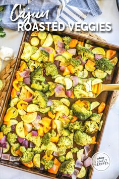 a tray filled with roasted veggies on top of a table next to other vegetables