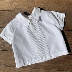 vintage kids 60s 70s white pleated short sleeve top Vintage 60s 70s white pleated shirt sleeve button back Great preowned condition No tags / labeled Probably for around 12 mos 10” long 10.5” pit to pit 10.5” across waist 3.5” sleeve Cotton or cotton poly blend Price includes flat rate expedited usps shipping Fitted Pleated Summer Tops, White Pleated Tops For Summer, Fitted Cotton Pleated Top, Classic Cotton Tops With Peter Pan Collar, Summer Pintuck Short Sleeve Tops, Classic Fitted Shirt With Peter Pan Collar, Summer Fitted Blouse With Pintucks, Casual Pintuck Short Sleeve Tops, Casual Short Sleeve Tops With Pintucks