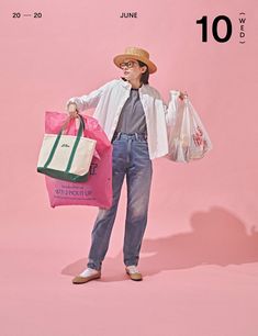 a man holding two shopping bags in one hand and wearing a hat on the other