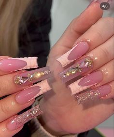 a woman with pink and gold nail polish on her nails