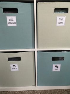 four storage bins with labels on them