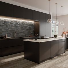 a modern kitchen with black cabinets and white counter tops, along with an island in the middle