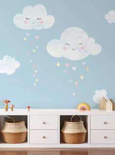 a child's room with clouds and hearts painted on the wall