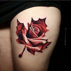 a woman's thigh with a rose tattoo on it