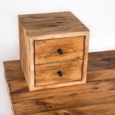 two wooden drawers sitting on top of each other