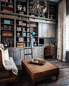 a living room filled with lots of furniture and bookshelves