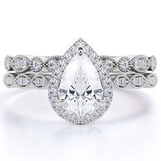 a pear shaped diamond engagement ring with matching band