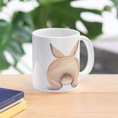 a white coffee mug with a dog's head on it sitting on a table