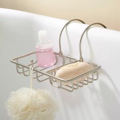 a bathtub with soap, shampoo and sponges hanging from it's sides