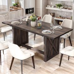 a dining room table with white chairs around it