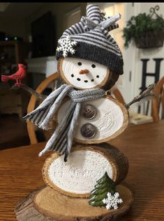 a snowman made out of wood sitting on top of a table