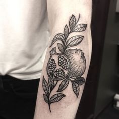 a black and white tattoo on the arm of a man's arm with flowers