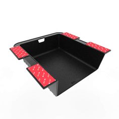 a black tray with red polka dots on the bottom and two red spots on the sides