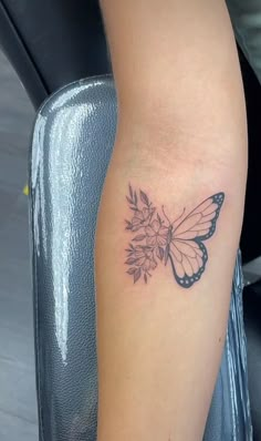 a woman's leg with a butterfly tattoo on it