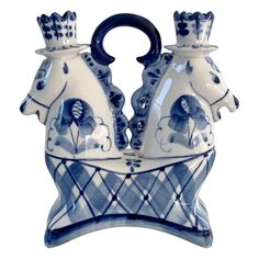 a blue and white vase with two horses on it's sides, one is holding a cup